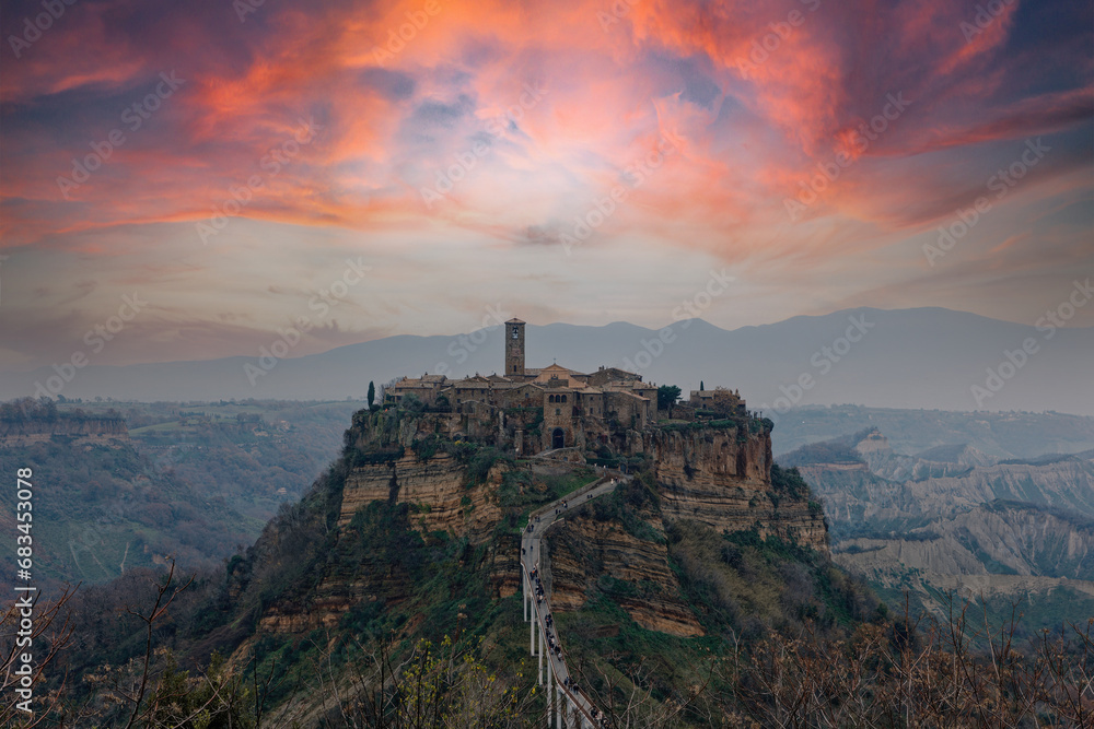Civita di Bagnoreggio ancient medieval village in Italy. Tourists from all over the world come to see the dying city on the mountain. sunset and clouds. travel picturesque and powerful village concept - obrazy, fototapety, plakaty 