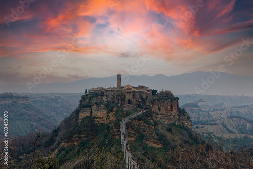 Civita di Bagnoreggio ancient medieval village in Italy. Tourists from all over the world come to see the dying city on the mountain. sunset and clouds. travel picturesque and powerful village concept photo
