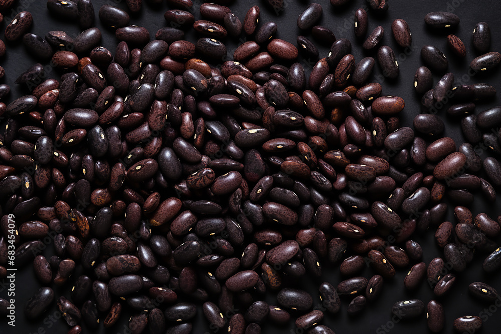 Many black and kidney beans on a black background, in the style of mottled Many black and kidney beans on a black background, in the style of mottled