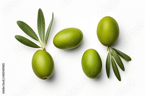 Three olives with leaves arranged on a white surface. Ideal for food and beverage concepts.