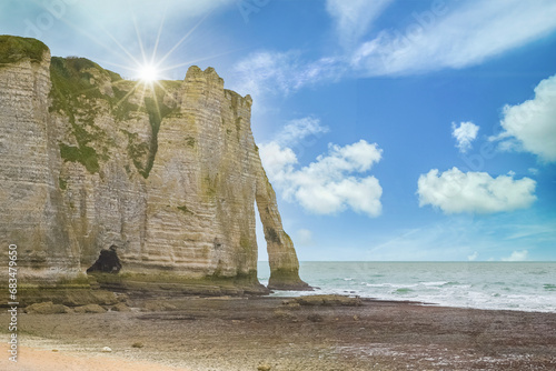 Etretat in Normandy, the famous cliffs and needle on the pebble beach 