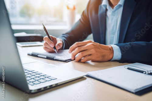 Close up of financial accountant sitting in his office and signing a great offer for his client, businessman in suit signing great deal