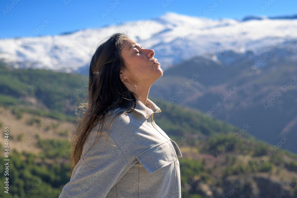 profile portrait of latina woman on snowy mountain background profile portrait of latina woman on snowy mountain background