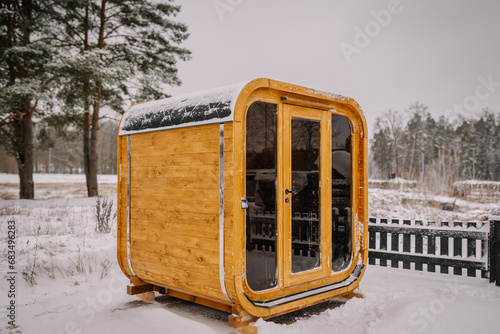 Wooden sauna in a snowy landscape