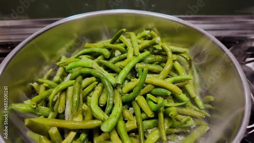 Dreamy clip of green beans in pot cooking on stove, haricots verts photo