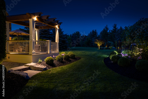 Beautiful custom built deck and pergola at night. photo