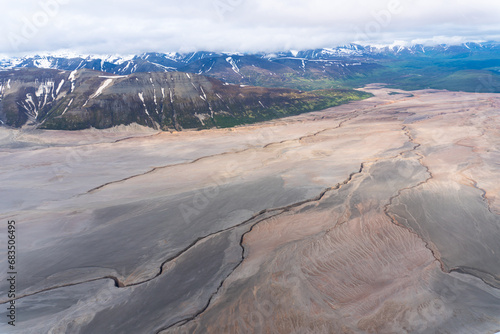 The Valley of Ten Thousand Smokes in Katmai National Park and Preserve in Alaska is filled with ash flow from Novarupta eruption in 1912. River eroding volcanic ash flow. Aerial view.