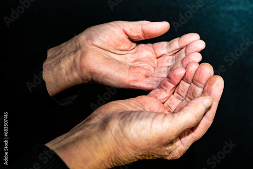 An elderly man, his hands are wrinkled. Asks for mercy.