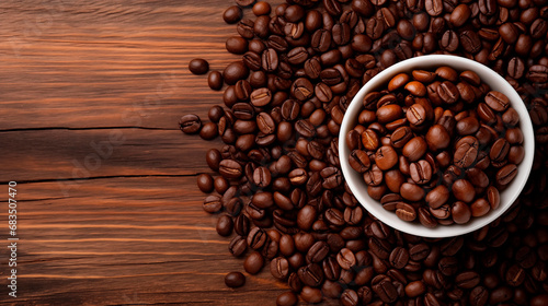 Roasted coffee beans on a dark wooden table and in a cup, top view. Background of aromatic brown coffee beans scattered on the surface, copy space. Place for text