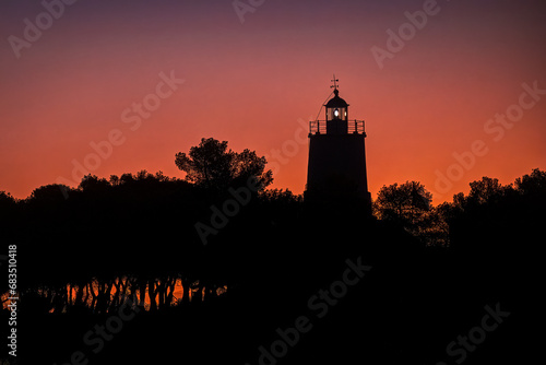 Beautiful lighthouse at dawn red hour, in Spetses island, Greece