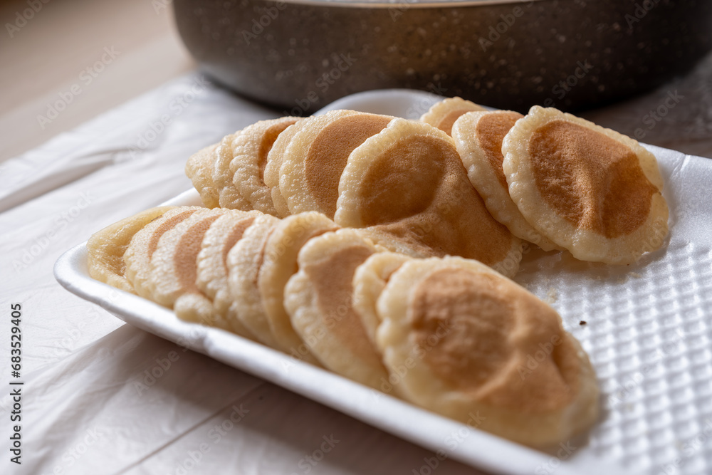 Qatayef plate ready to be filled and stuffed on wooden table Qatayef plate ready to be filled and stuffed on wooden table
