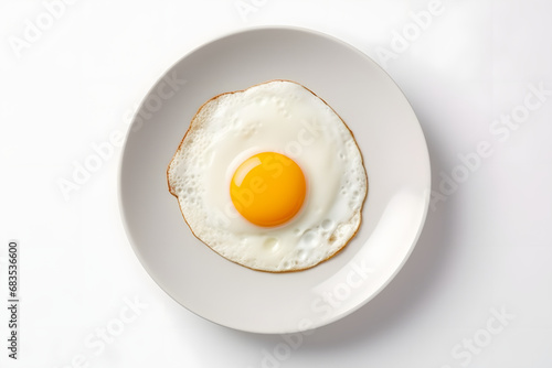 One fried egg on white plate isolated on white background, top view