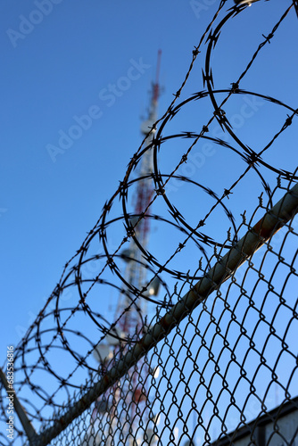 chainlink fence surrounding a communication tower