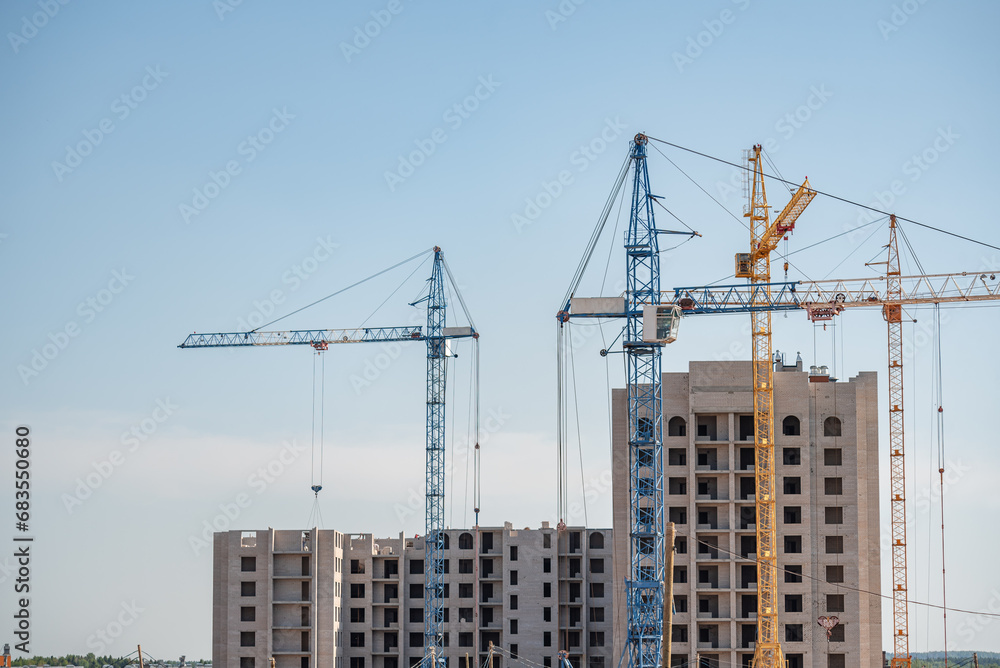 A construction site with a tower crane erecting a new house.