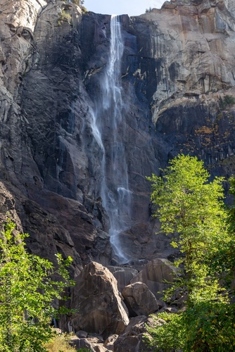 Famous Bridal Veil Fall or Waterfall Vertical Portrait, Low Autumn Water Flow, Granite Rock Cliff. Yosemite National Park, Sierra Nevada California USA photo