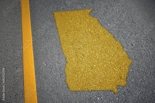 Obraz na płótnie yellow map of georgia state on asphalt road near yellow line.