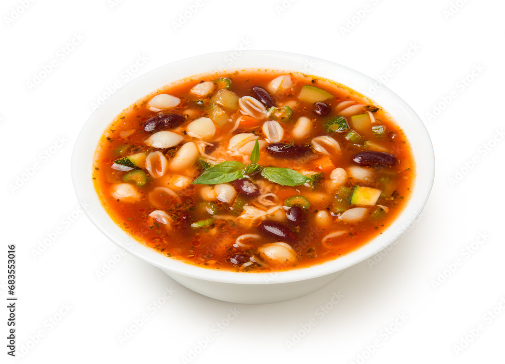 Italian minestrone soup in a white porcelain soup bowl isolated on a white background. Italian minestrone soup in a white porcelain soup bowl isolated on a white background.