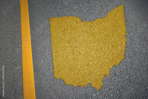 yellow map of ohio state on asphalt road near yellow line.