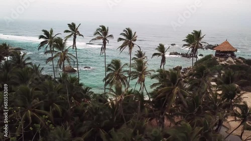 Aerial drone footage of the paradise nature at sunset in Tayrona National Park, Colombia, Latin America. Cabo San Juan kiosk, Turquoise sand beach and white rocks of Caribbean coast. 4k footage. photo