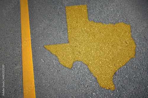 yellow map of texas state on asphalt road near yellow line.
