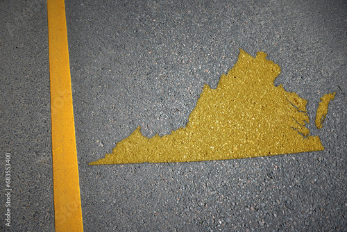 yellow map of virginia state on asphalt road near yellow line. photo