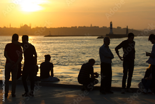 People watching the panorama of Istanbul from Kadıköy at sunset photo