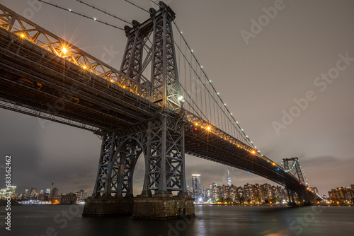 The Williamsburg Bridge is a suspension bridge in New York City across the East River connecting the Lower East Side of Manhattan at Delancey Street with the Williamsburg neighborhood of Brooklyn photo