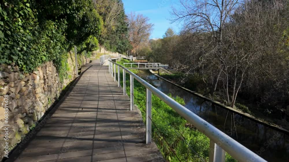 Hiker's point of view along the Corgo river city park in Vila Real, Portugal. Hiker's point of view along the Corgo river city park in Vila Real, Portugal.