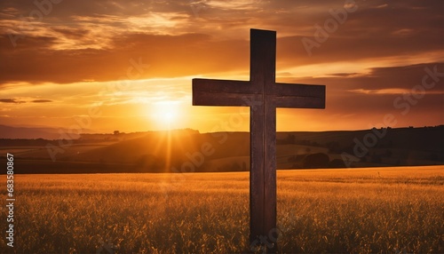 Silhouette of Christian cross on grass at sunrise - spiritual, serene scene
