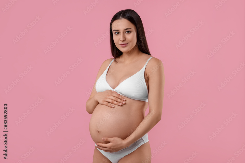 Beautiful pregnant woman in stylish comfortable underwear on pink background Beautiful pregnant woman in stylish comfortable underwear on pink background