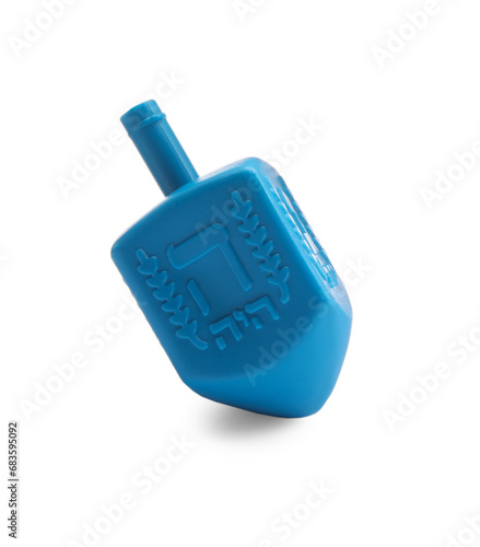 One light blue dreidel isolated on white. Traditional Hanukkah game photo