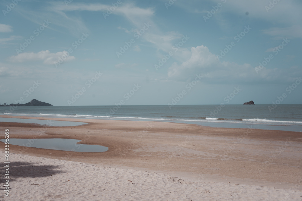 The beautiful beach in Khao Tao Beach, Hua Hin, Thailand. Cloud sky over beach The beautiful beach in Khao Tao Beach, Hua Hin, Thailand. Cloud sky over beach