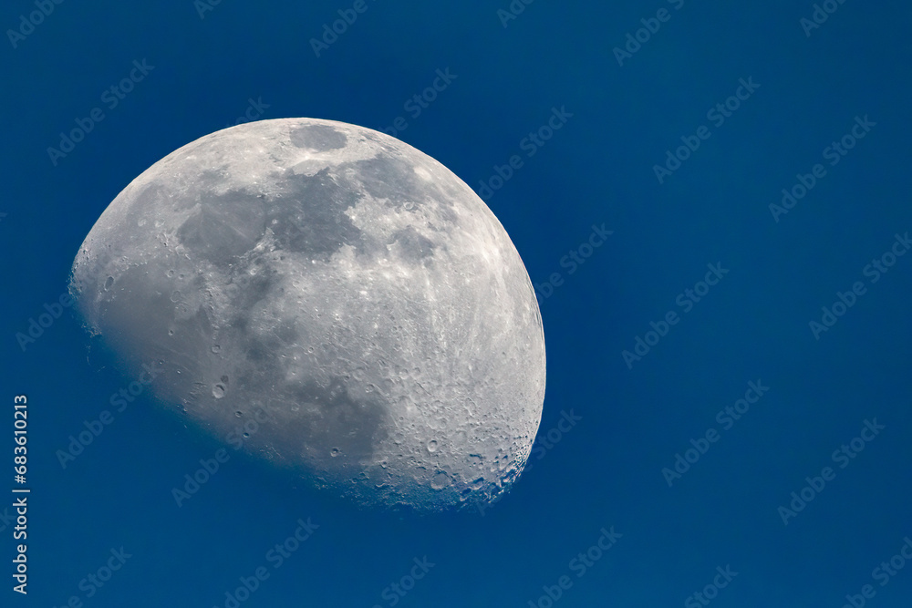 3/4 moon against a cloudless blue sky 3/4 moon against a cloudless blue sky