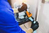 Technician plumber using a wrench to repair a water pump pipe. Concept of maintenance, fix water plumbing leaks drop or house bathroom service or cleaning clogged pipes is dirty or rusty.