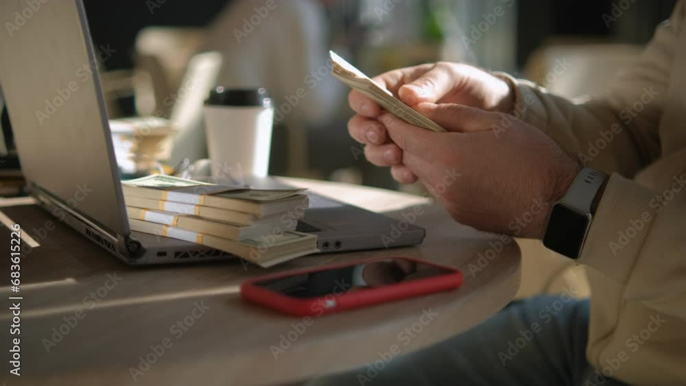 Young man counts cash money dollars sits at desk workplace. Male happy about income. Successful business man modern entrepreneur, self-employed concept. 4K Young man counts cash money dollars sits at desk workplace. Male happy about income. Successful business man modern entrepreneur, self-employed concept. 4K