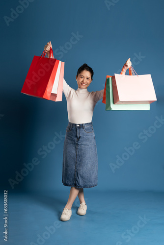 Image of beautiful Asian woman posing on blue background