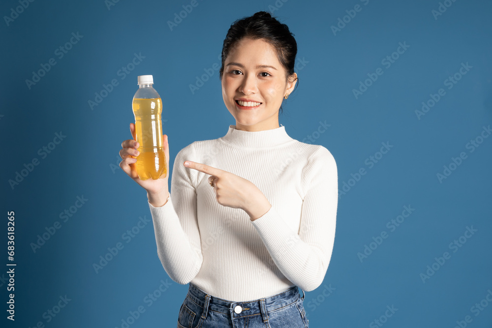 Portrait of beautiful asian girl posing on blue background Portrait of beautiful asian girl posing on blue background