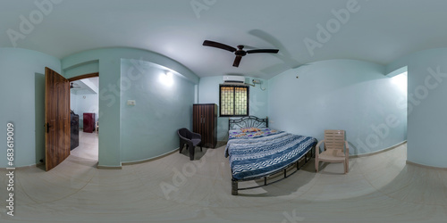 full seamless spherical hdri 360 panorama in interior of cheap bedroom guesthouse with blue walls and indian style with ceiling fan in equirectangular projection,  VR content photo