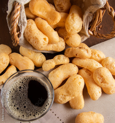 Traditional Brazilian starch biscuit falling from a basket into table with coffee