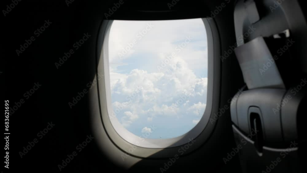 view through the plane window with thick cloud above the beautiful sky, clouds over sea ocean coast landscape view through the plane window with thick cloud above the beautiful sky, clouds over sea ocean coast landscape