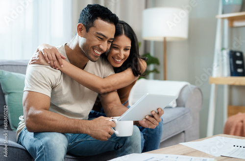 Happy couple, hug and tablet for social media on sofa in house for funny joke, meme or post. Man, woman and smile in excitement with coffee for article on internet, mobile app and web for relaxing