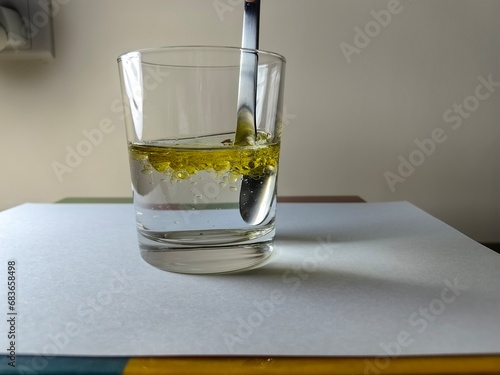 Mix olive oil with a spoon in water