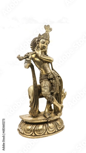 golden statue of lord krishna crafted with details, an avatar of vishnu, playing flute music near a cow in a dancing position, isolated in a white background