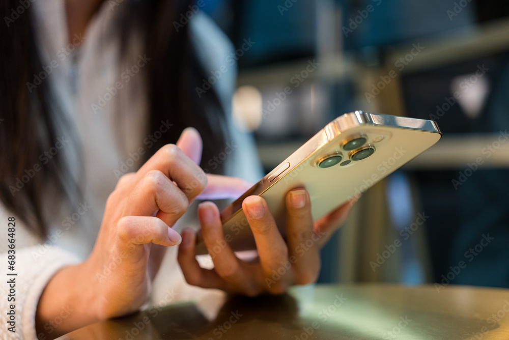 Woman use of mobile phone in cafe