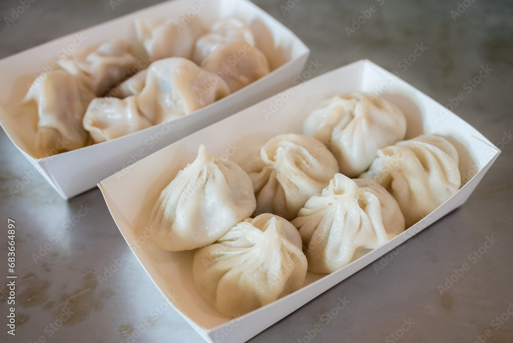 Steamed pork meat soup bun in the take away box Steamed pork meat soup bun in the take away box