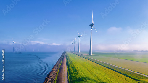 Windmill turbines Park with a blue sky, windmill turbines in the ocean © Chirapriya