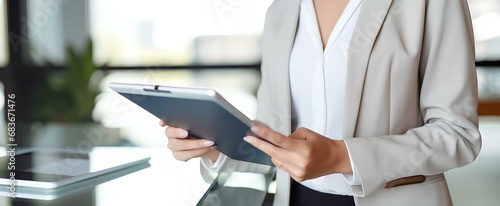 Busy young business woman executive holding pad computer at work. female professional employee using digital tablet fintech device standing in office checking financial online data. generative AI