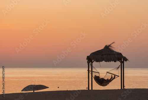couple in a hammock at the beach waiting for the sunrise photo
