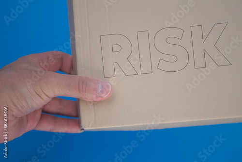 Risk word with cardboard box. Brown folded card box.