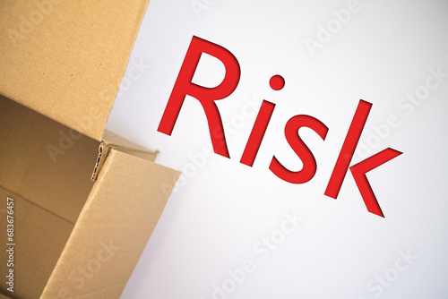 Risk word with cardboard box. Brown folded card box.